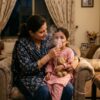 Parent giving a child a nebulizer treatment at home
