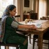 Woman checking blood pressure at home with correct sitting posture