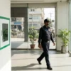 A public access AED mounted in an office lobby, placed to be reached within three minutes